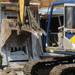 A backhoe pushes through the front door of a home destroyed by a tornado in the Dexter subdivision of Huron Farms on Monday. Melanie Maxwell I AnnArbor.com